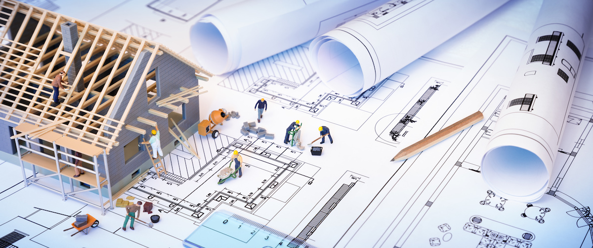 house under construction on blueprints – building project